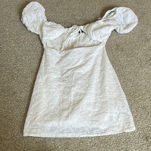 White kittenish puff shoulder with open front